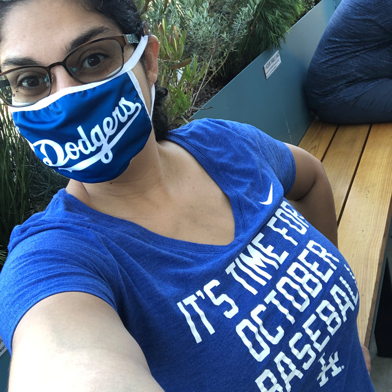 Li Yun wearing a dodgers mask and a t-shirt that says: It's time for October Baseball